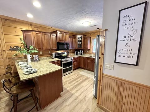 Kitchen area is fully stocked with quality cookware and utensils