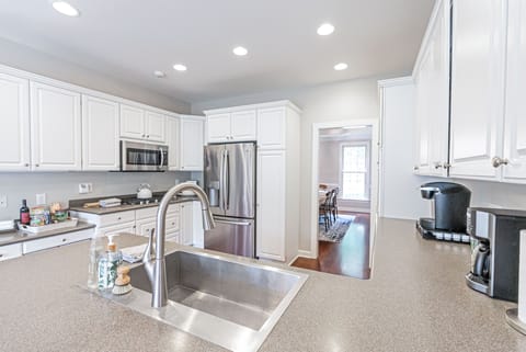 Kitchen wth SS fridge and microwave