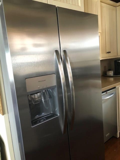 Stainless steel side-by-side refrigerator with ice and water in the door.