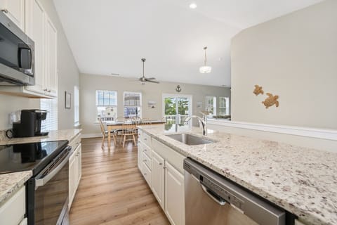 Gleaming Granite and Stainless Appliances.