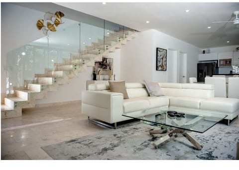  A large living room featuring white couches. 