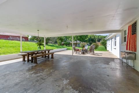 Great outdoor space with farmhouse table, outdoor cooler and fire pit