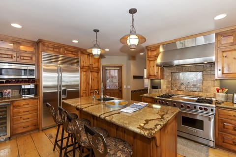 Gourmet kitchen features Wolf oven with griddle, subzero fridge and two sinks!