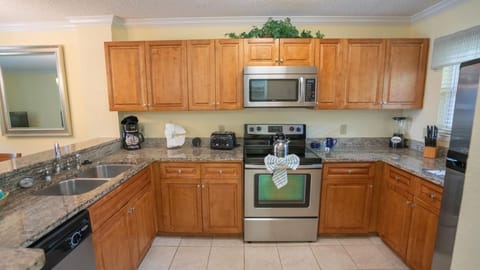 Cook with ease in a full kitchen with stainless appliances