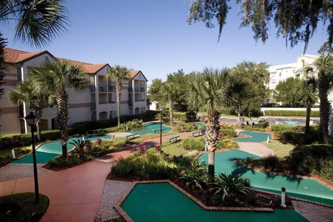 Challenge friends to a playful mini-golf round among palms.