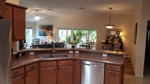 KITCHEN LOOKING INTO LIVING AREA AND DINING ROOM