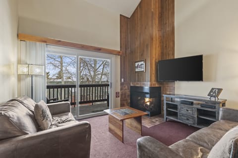 Snow Flower 127's living room with cozy couches and gas burning fireplace.