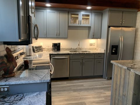 Fully equipped kitchen with stainless appliances.