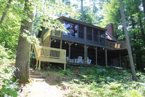 Back of house with new added stairs out to pond. 