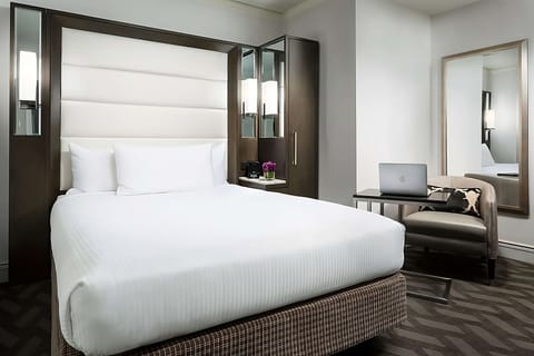 Settle in with a calm workspace beside your restful bed.