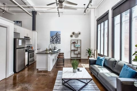 Relax in this cozy, modern living room featuring chic décor, comfortable seating, and warm lighting that creates the perfect ambiance for unwinding in the heart of downtown Fort Worth.