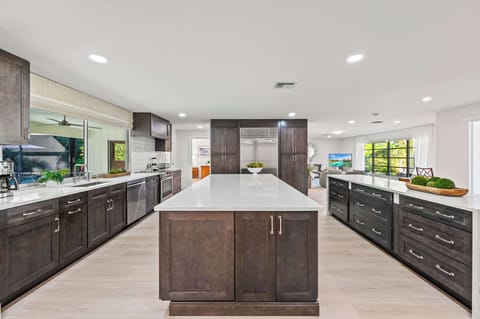 Modern Kitchen with Stainless Steel Appliance; Stools for Dining at the Island