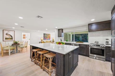 Modern Kitchen with Stainless Steel Appliance; Stools for Dining at the Island