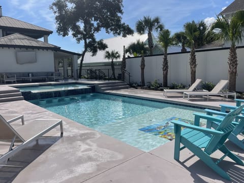 Heated pool with swim up bar, hot tub and 65” tv