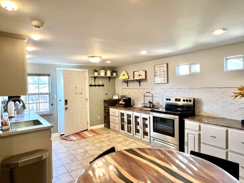 kitchen 
A wine cooler, microwave, stove, oven, toaster and more.