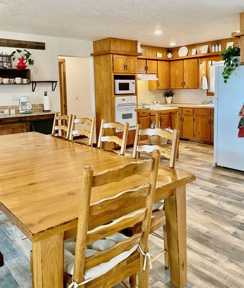 Roomy farmhouse table, kitchen and coffee bar/buffet on the left side