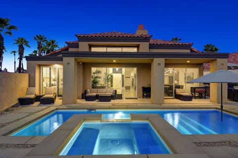 REAR VIEW OF HOUSE SPA AND POOL AT NIGHT
