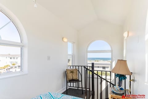 Bright sunroom with cozy seating and scenic window views