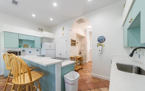 Bright, airy kitchen with cozy breakfast bar seating