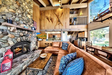 Ample seating around the gas fireplace on the new couch under the homes vaulted ceilings