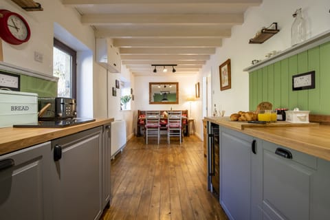 Ground floor: Dining kitchen with rear door leading out to the patio area