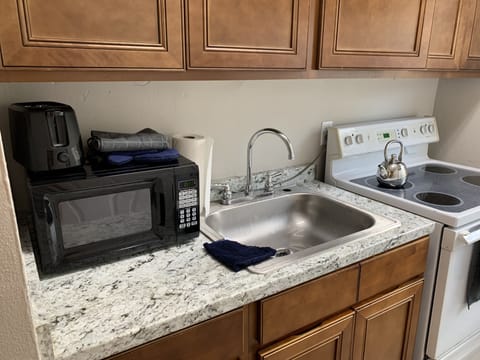 Full Kitchen with stove, oven, fridge, microwave and toaster 