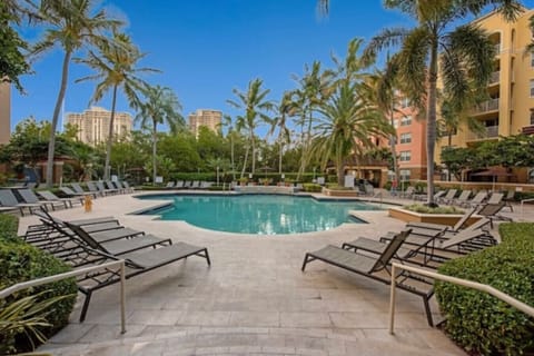 Resort-style pool surrounded by palm trees in a secure gated community.