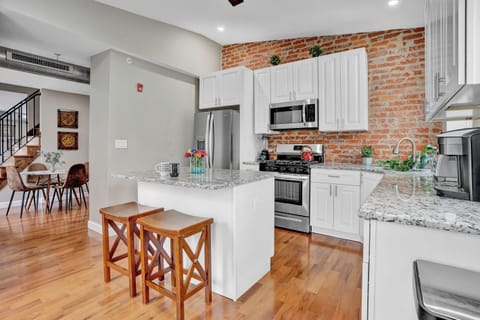 Upon stepping through the front door, your gaze will immediately be drawn to the original brick wall in the kitchen! This distinctive feature silently narrates stories of the past while adding a unique charm and character to the place