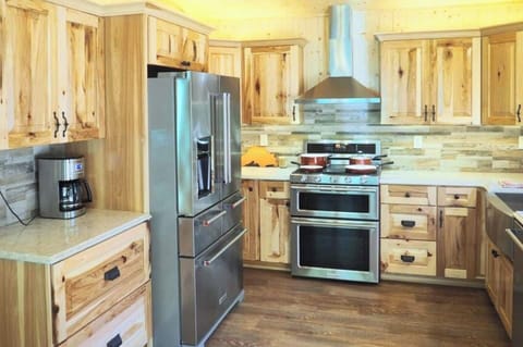 This kitchen has it all! Gas stove, double oven, gorgeous fridge, microwave, coffee maker, and even a dishwasher! your home kitchen is gonna be jealous...