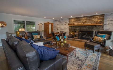 Stone fireplace and accent wall in living room
