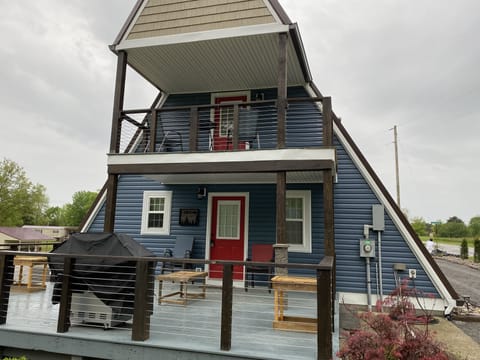 Spacious back deck with gas grill, seating and tables.