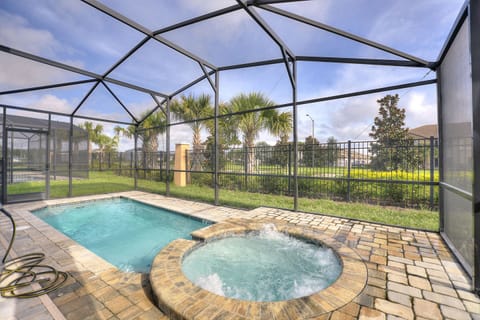 Screened private pool and relaxing spa with seating area and water view