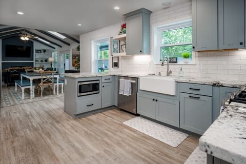 Open concept kitchen with ample counter space, farmhouse sink and gas range