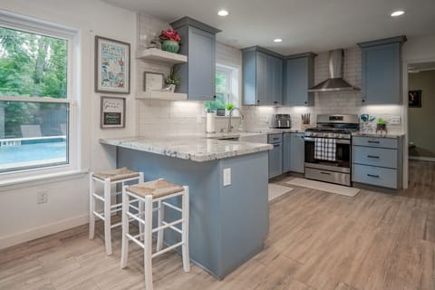 Open concept kitchen with ample counter space, farmhouse sink and gas range