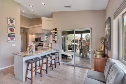 Bar seating and access to back yard & covered patio.