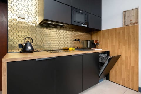 Sleek kitchen with gold accents and high-end appliances.