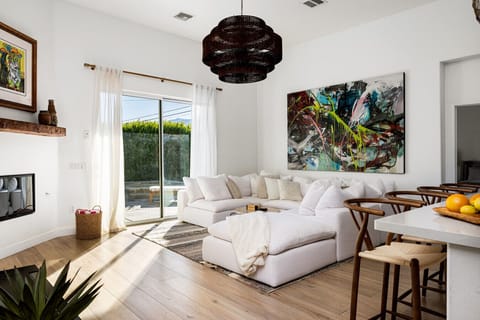 Spacious family lounge with comfy seating and sunlight spilling in from the poolside patio