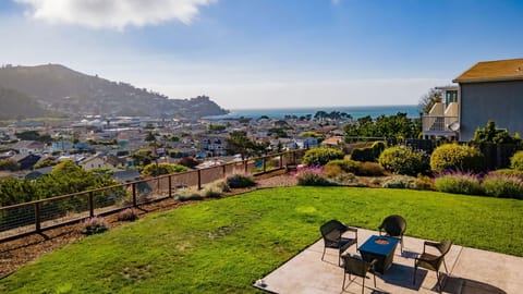 Spacious outdoor seating with table, chairs, and a beautiful ocean view