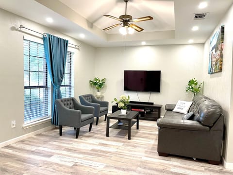 Unit 1 - Living room with smart TV, sofa, board games. 