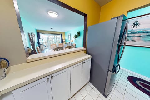 Kitchen has new stainless French door style refrigerator and new oven.  Open to the dining table and main living space.