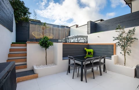 Outdoor area with hot tub and dining area