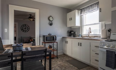 The dining table and chairs are located in the eat-in kitchen.