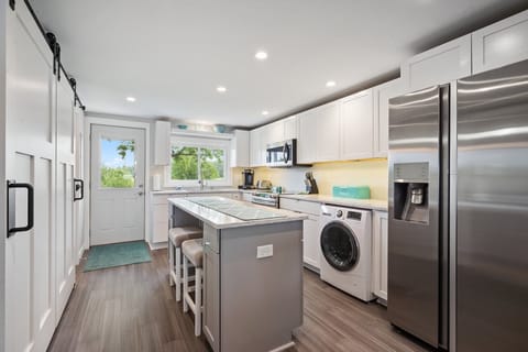 Full kitchen view with two stools under island