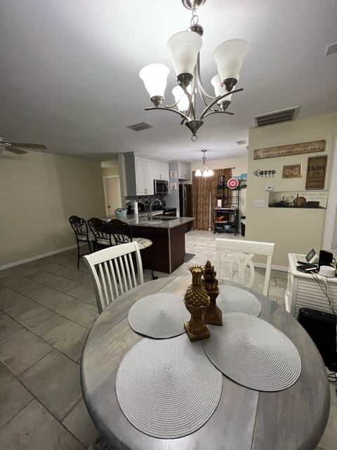 Living area & dining table for 4 plus @ 3 stools at bar