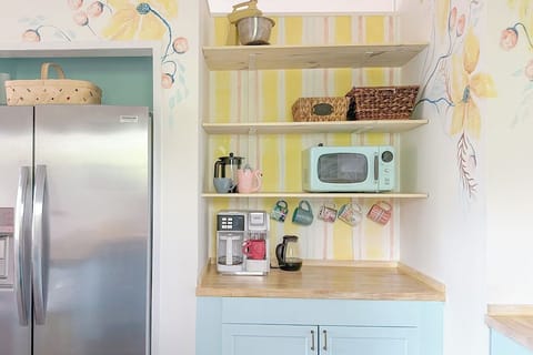 Coffee bar is stocked with coffee, creamers, and sugar options.