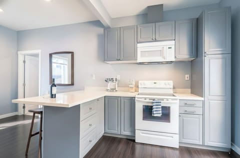 Modern gray-and-white kitchen perfect for preparing meals during your stay.