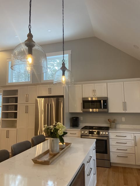 Kitchen with island seating for four and Bosch stainless steel appliances.