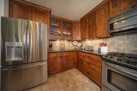 - Full kitchen with stainless steel fridge and modern appliances   - Granite counters and wooden cabinets stocked for cooking ease   - Cook homemade meals after mountain adventures in comfort