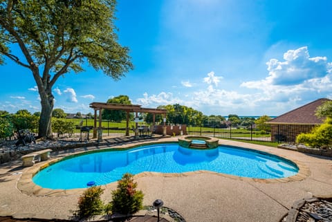 Backyard with heated pool, spa, grill, patio and outdoor dining.