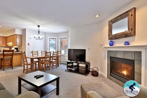 Bright open living room with gas fireplace.